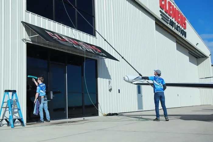 professionals cleaning commercial property windows